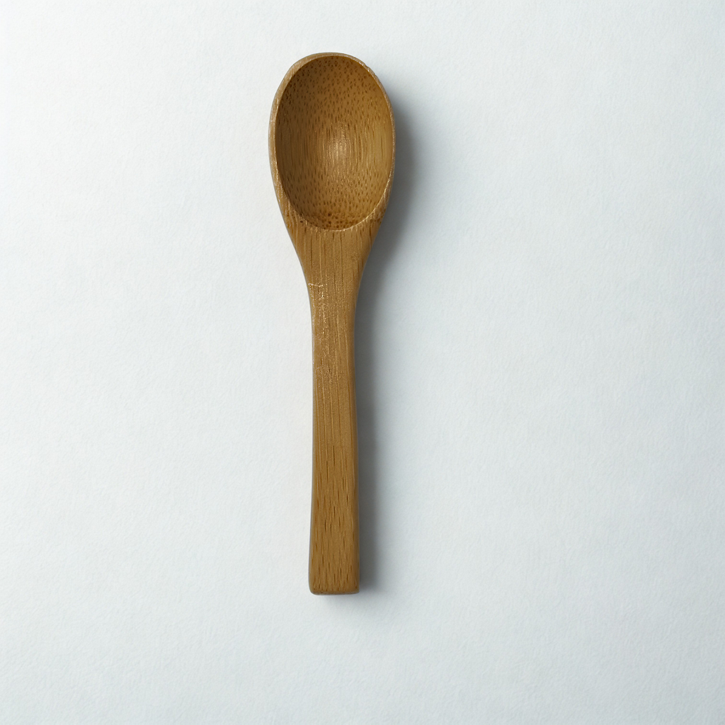 Wooden spoon on a white surface