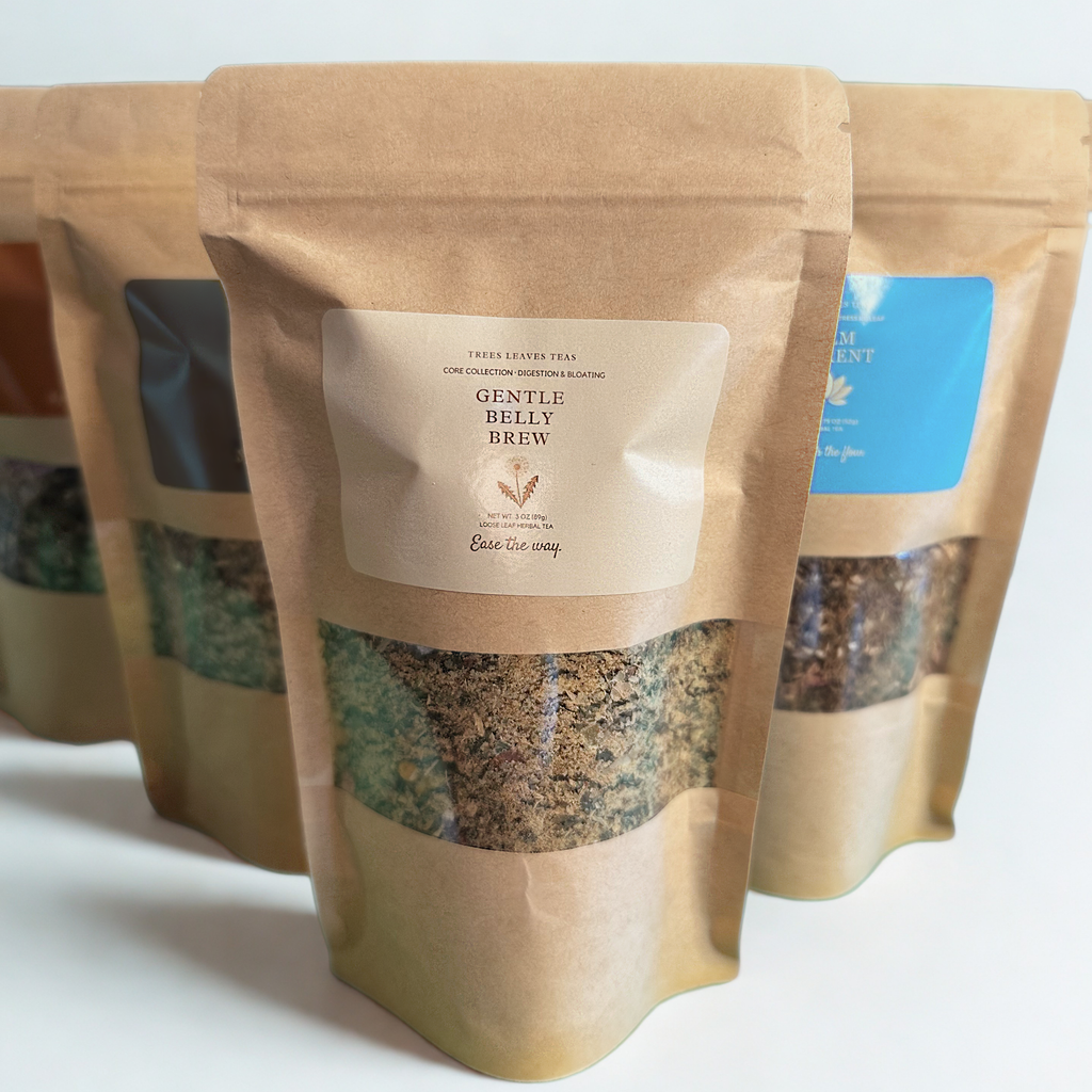 Tea packages with visible tea leaves and brand labels by Trees Leaves Teas on a white background