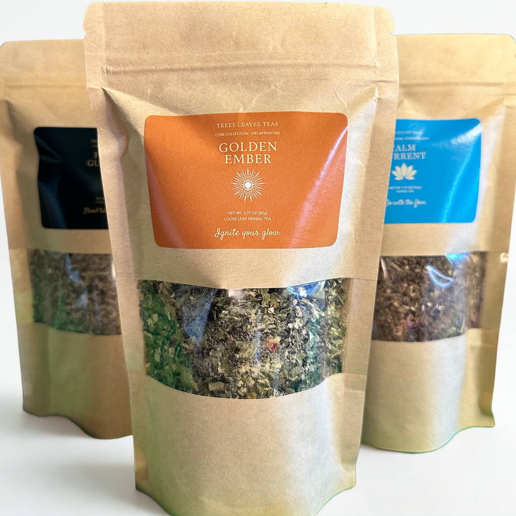 Tea packages with visible tea leaves and brand labels by Trees Leaves Teas on a white background