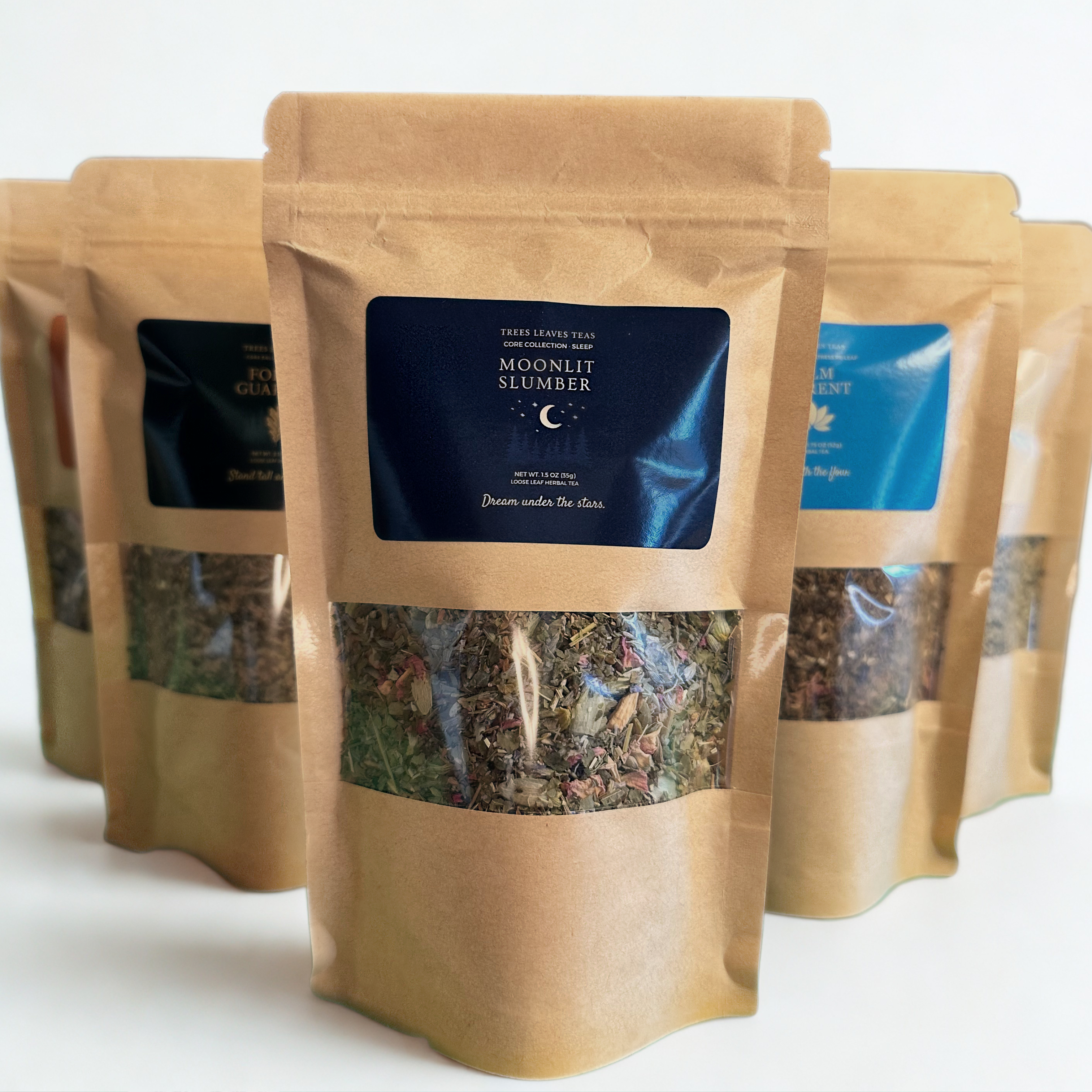 Row of brown Kraft packages with 'Moonlit Slumber' label by Trees Leaves Teas on a white background