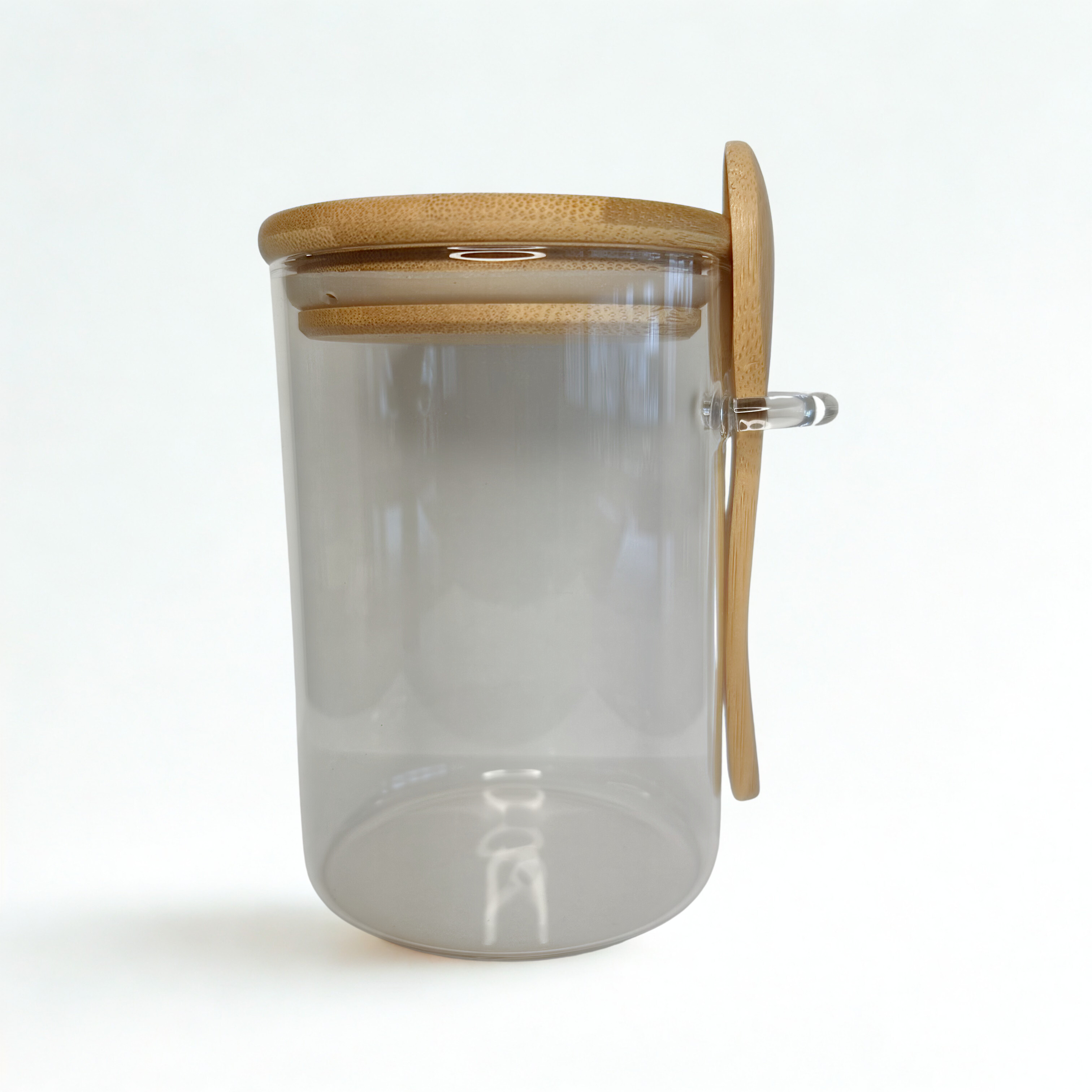 Cylindrical glass storage jar with bamboo lid and spoon holder